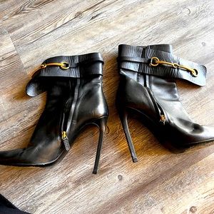 Black leather Gucci ankle heel boots.